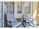 Comfortable screened porch featuring two chairs, a table, and natural light, perfect for outdoor relaxation at 305 Terrace Ridge Cir # 305, Davenport, FL 33896