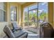 Cozy screened porch with comfortable seating, offering an ideal space for relaxing outdoors at 305 Terrace Ridge Cir # 305, Davenport, FL 33896