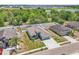 Aerial view of a cozy home displaying a well-manicured lawn, and a large fenced-in backyard with trees in the distance at 344 Highland Meadows St, Davenport, FL 33837