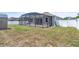 View of the backyard with screened-in patio, shed, and fencing at 344 Highland Meadows St, Davenport, FL 33837