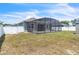 View of the backyard, featuring a screened patio, shed, green space, and white fencing at 344 Highland Meadows St, Davenport, FL 33837