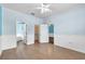 Spacious bedroom with wood-style tile flooring, ceiling fan, and ample natural light at 344 Highland Meadows St, Davenport, FL 33837