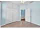 Bright bedroom featuring wood-look tile floors, a ceiling fan, and a double door closet at 344 Highland Meadows St, Davenport, FL 33837