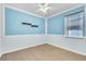 Bedroom with a light blue paint, decorative shelves and wood-style tile flooring at 344 Highland Meadows St, Davenport, FL 33837