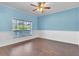 Bedroom featuring wood floors, a ceiling fan, and a large window with natural light at 344 Highland Meadows St, Davenport, FL 33837