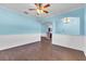 Dining room with blue and white walls, wood floors, and a view into the kitchen at 344 Highland Meadows St, Davenport, FL 33837