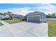 Beautiful single-story residence featuring a lush lawn, elegant gray paint, and a convenient two-car garage at 344 Highland Meadows St, Davenport, FL 33837