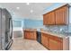Kitchen featuring granite counters, stainless steel appliances, wood cabinets, and tile floors at 344 Highland Meadows St, Davenport, FL 33837