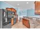 View of the kitchen with stainless steel appliances and a breakfast bar with beautiful tile at 344 Highland Meadows St, Davenport, FL 33837