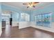 Open-concept living room featuring hardwood floors, white wainscoting, blue accent walls, and abundant natural light at 344 Highland Meadows St, Davenport, FL 33837