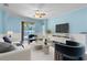 Bright living room featuring modern furniture, a ceiling fan, and sliding glass doors to the outside at 344 Highland Meadows St, Davenport, FL 33837