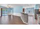 Open-concept living space featuring sleek floors, half wall kitchen bar, and sliding doors to the lanai at 344 Highland Meadows St, Davenport, FL 33837