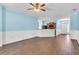 Bright living area with sleek wood floors, modern ceiling fan, and open layout to the kitchen and dining at 344 Highland Meadows St, Davenport, FL 33837