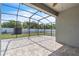 Spacious screened patio with neutral-toned tile flooring, offering an outdoor entertaining space at 344 Highland Meadows St, Davenport, FL 33837