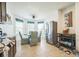 Cozy dining area boasts a charming table, stainless steel refrigerator, and modern tile flooring at 3679 Julius Estates Blvd, Winter Haven, FL 33881