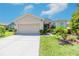 Charming single-story home with a well-manicured lawn and two-car garage on a sunny day at 3679 Julius Estates Blvd, Winter Haven, FL 33881