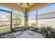 Comfortable screened lanai with seating, a ceiling fan, and views of the backyard at 3679 Julius Estates Blvd, Winter Haven, FL 33881