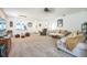 Bright living room featuring neutral carpet, ceiling fan, comfortable couches and open space at 3679 Julius Estates Blvd, Winter Haven, FL 33881