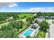 Aerial view of a community pool area with lounge chairs, surrounded by greenery and residential buildings at 3679 Julius Estates Blvd, Winter Haven, FL 33881
