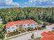 Aerial view of community showcasing manicured landscaping, red tile roofs, and mature trees, creating a serene residential environment at 4504 Alberto Cir, Kissimmee, FL 34746