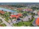 Beautiful aerial view of the community, showcasing the clubhouse, pool, and surrounding homes by the lake at 4504 Alberto Cir, Kissimmee, FL 34746