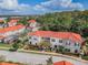 Overhead shot of the community showcasing multiple townhomes with red tile roofs, lush landscaping, and a well-maintained environment at 4504 Alberto Cir, Kissimmee, FL 34746