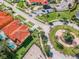 Aerial of bright homes, immaculate landscaping, dog park, and roundabout at 4504 Alberto Cir, Kissimmee, FL 34746