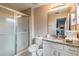 Bathroom features a glass enclosed shower, toilet and granite vanity with ample counter space at 4504 Alberto Cir, Kissimmee, FL 34746