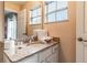 Well-lit bathroom with granite countertop, vanity and large mirror, providing a functional space at 4504 Alberto Cir, Kissimmee, FL 34746