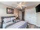 This bedroom includes a ceiling fan, mounted TV, closet, and beach-themed decor at 4504 Alberto Cir, Kissimmee, FL 34746