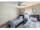 This bedroom features two twin beds, a ceiling fan, wood floors and natural light from the window at 4504 Alberto Cir, Kissimmee, FL 34746