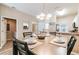 Inviting dining area features a modern chandelier and seating for four, adjacent to kitchen at 4504 Alberto Cir, Kissimmee, FL 34746