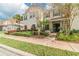 Townhome with red tile roof, neutral paint, and well-maintained landscaping, offering curb appeal and charm at 4504 Alberto Cir, Kissimmee, FL 34746