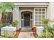 Inviting front door of unit 4504 with decorative lattice and palm tree at 4504 Alberto Cir, Kissimmee, FL 34746