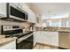 Beautiful kitchen featuring granite countertops, stainless steel appliances, and white cabinets at 4504 Alberto Cir, Kissimmee, FL 34746