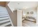 Cozy living room adjacent to the staircase features comfortable seating and modern decor at 4504 Alberto Cir, Kissimmee, FL 34746