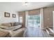 Cozy living room with access to pool area and wood floors at 4504 Alberto Cir, Kissimmee, FL 34746