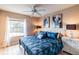 Stylish main bedroom with plush bedding, accent furniture, and soft natural light from the window at 4504 Alberto Cir, Kissimmee, FL 34746