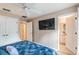 Spacious main bedroom featuring ensuite bathroom, closet space and a large TV at 4504 Alberto Cir, Kissimmee, FL 34746