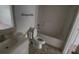 Small bathroom with a toilet, sink, bathtub, and shower at 459 Danube Dr, Poinciana, FL 34759