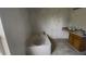 Bright bathroom featuring a tub, a vanity with wooden cabinets, and partially painted walls at 459 Danube Dr, Poinciana, FL 34759