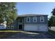Charming two-story home with a three-car garage and arched windows against a clear blue sky at 459 Danube Dr, Poinciana, FL 34759