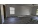 Spacious living room with new floors, fresh paint, ceiling fan, and natural light at 459 Danube Dr, Poinciana, FL 34759