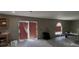 Partially renovated living room with concrete flooring and access to the outdoors through sliding glass doors at 459 Danube Dr, Poinciana, FL 34759