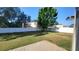 Lush green backyard featuring a white fence and shade trees perfect for enjoying outdoor activities and relaxing at 461 Fish Hawk Dr, Winter Haven, FL 33884