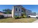 Charming two-story home featuring a well-manicured lawn, lush landscaping, and a two-car garage, perfect for Gathering living at 461 Fish Hawk Dr, Winter Haven, FL 33884