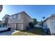 Side view of a two-story home with a two-car garage and a view of a blue sky at 461 Fish Hawk Dr, Winter Haven, FL 33884