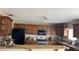 Kitchen features wooden cabinets, granite countertops, and stainless appliances at 461 Fish Hawk Dr, Winter Haven, FL 33884