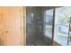 Shower with clear glass door, blue tile, gold trim, and tiled shower floor at 461 Fish Hawk Dr, Winter Haven, FL 33884
