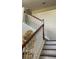 Staircase leading up to the upper level with wooden handrail at 461 Fish Hawk Dr, Winter Haven, FL 33884